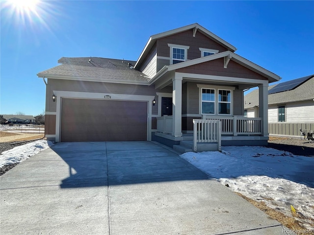 view of front of property featuring a garage and covered porch