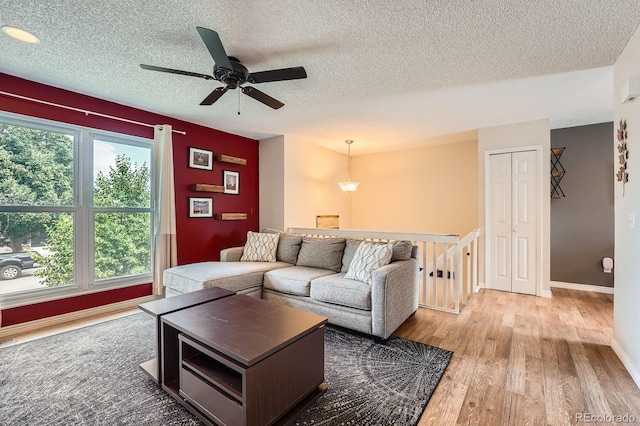 19196 E Kansas Dr, Aurora, CO 80017 - living room with light wood-type flooring, a textured ceiling, and ceiling fan