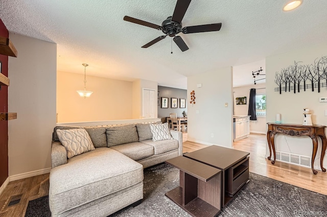 19196 E Kansas Dr, Aurora, CO 80017 - living area featuring wood finished floors, ceiling fan, and a textured ceiling