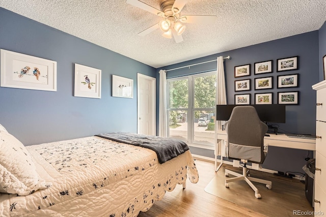 19196 E Kansas Dr, Aurora, CO 80017 - bedroom with wood finished floors, a textured ceiling, a desk, and ceiling fan