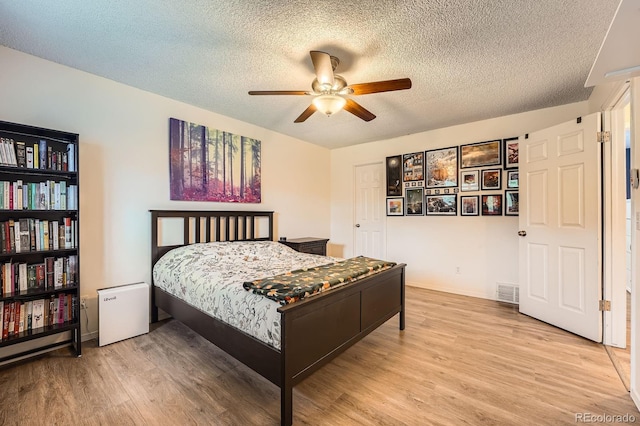 19196 E Kansas Dr, Aurora, CO 80017 - bedroom featuring a textured ceiling, wood finished floors, and ceiling fan