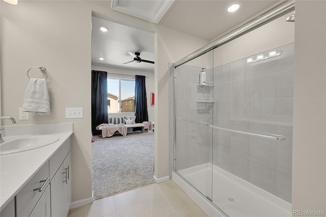 bathroom with tile patterned floors, ensuite bathroom, baseboards, a shower stall, and vanity