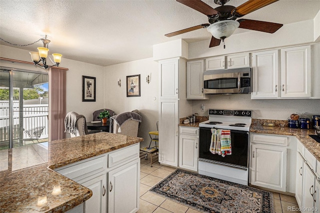 2813 S Xanadu Way, Aurora, CO 80014 - kitchen with stainless steel microwave, electric range oven, light tile patterned floors, a chandelier, and a ceiling fan