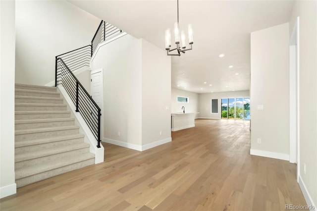 interior space featuring light wood-type flooring and a chandelier