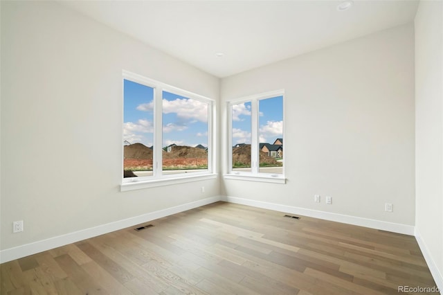 unfurnished room featuring light wood-type flooring