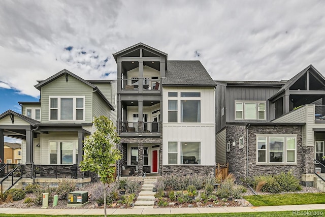 16546 Umatilla Pl, Broomfield, CO 80023 - view of property with a balcony, stone siding, and board and batten siding