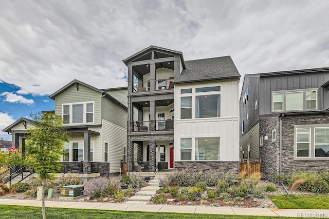 16546 Umatilla Pl, Broomfield, CO 80023 - view of front of property with a balcony, board and batten siding, and stone siding