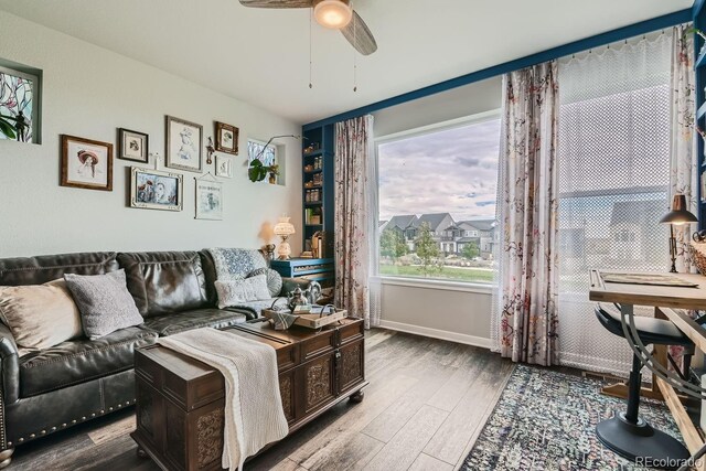 16546 Umatilla Pl, Broomfield, CO 80023 - living area with a ceiling fan, wood finished floors, and baseboards