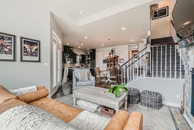 16546 Umatilla Pl, Broomfield, CO 80023 - living room featuring stairway, wood finished floors, recessed lighting, baseboards, and a chandelier