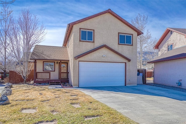 view of front of home with fence, driveway, stucco siding, and an attached garage
