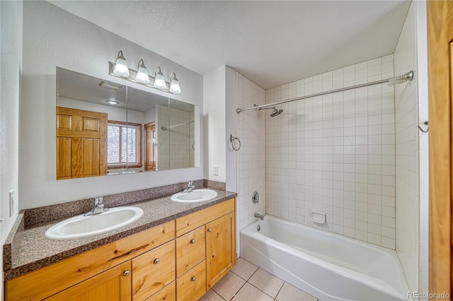 full bath with tile patterned floors, shower / bathing tub combination, double vanity, and a sink