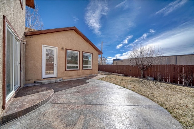 view of patio featuring fence