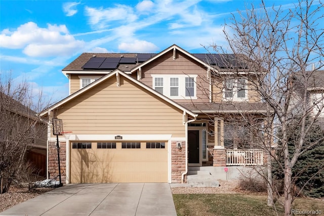 craftsman-style house with a porch, an attached garage, stone siding, and concrete driveway