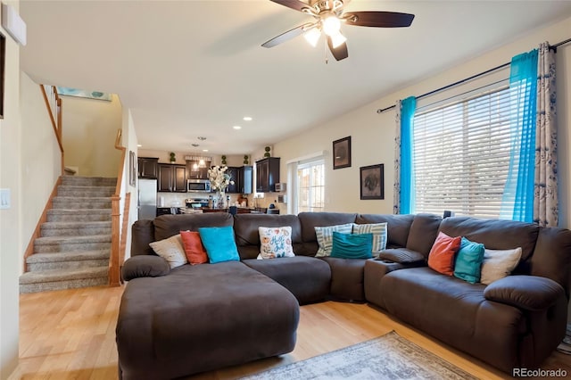 living room featuring stairs, recessed lighting, light wood-style floors, and a ceiling fan