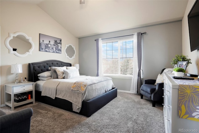 carpeted bedroom with lofted ceiling and baseboards