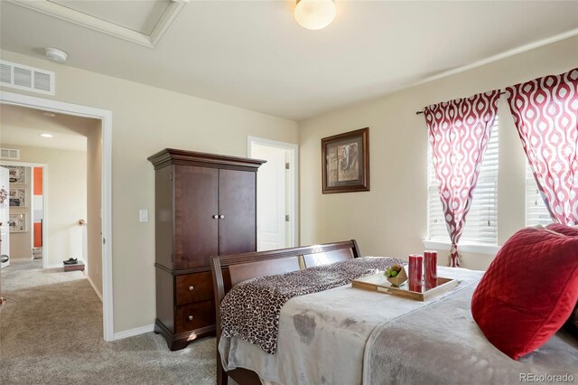 carpeted bedroom with baseboards and visible vents