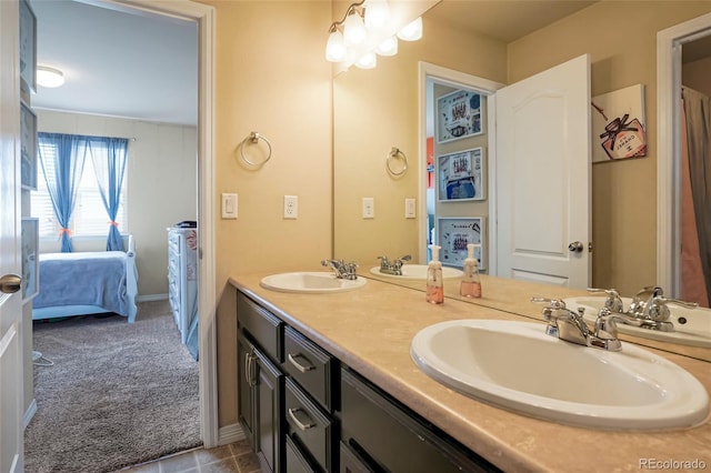 bathroom featuring double vanity, baseboards, and a sink