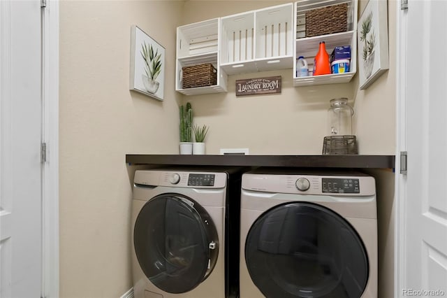 washroom featuring laundry area and washing machine and clothes dryer