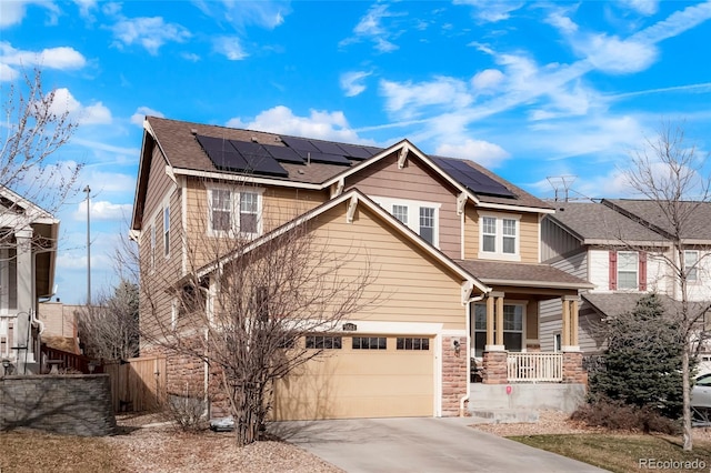 view of front of home with fence, driveway, solar panels, a porch, and a shingled roof