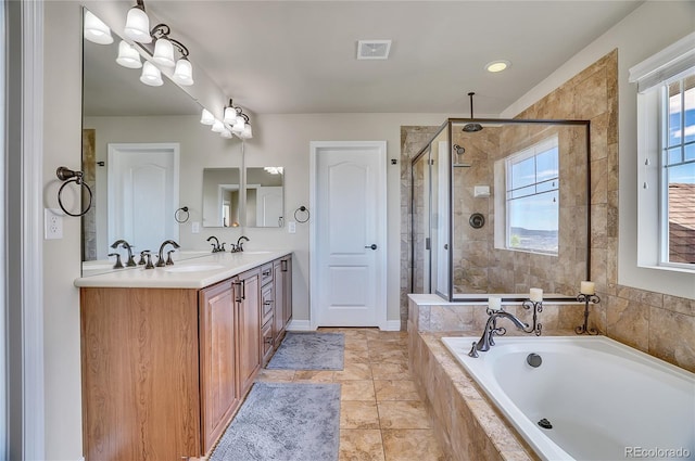 bathroom featuring tile patterned flooring, vanity, and plus walk in shower