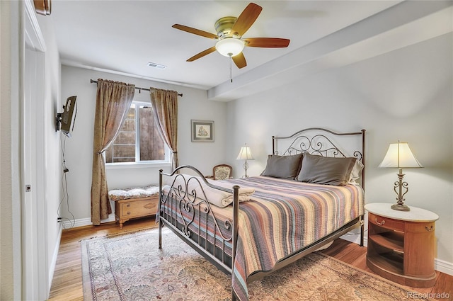 bedroom with ceiling fan and wood-type flooring