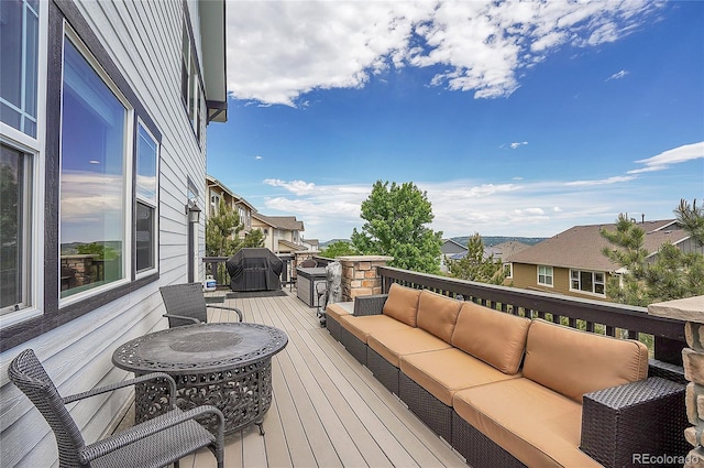 deck featuring an outdoor living space and a grill