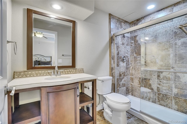 bathroom featuring ceiling fan, vanity, toilet, decorative backsplash, and a shower with shower door