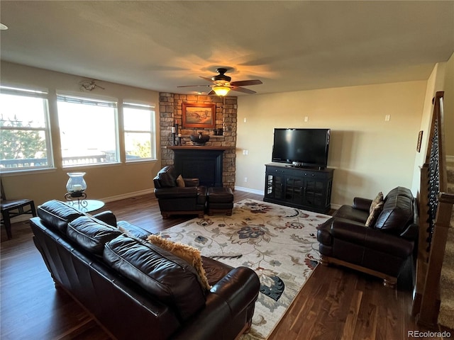 living room with ceiling fan, a fireplace, and dark hardwood / wood-style floors