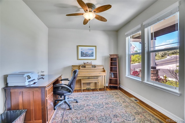 home office with ceiling fan and hardwood / wood-style flooring