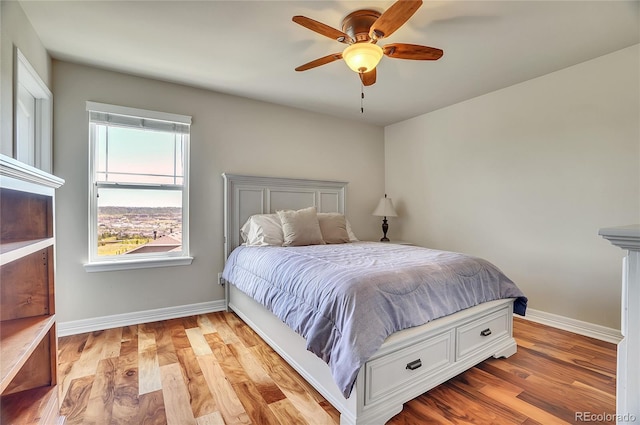 bedroom with ceiling fan and light wood-type flooring