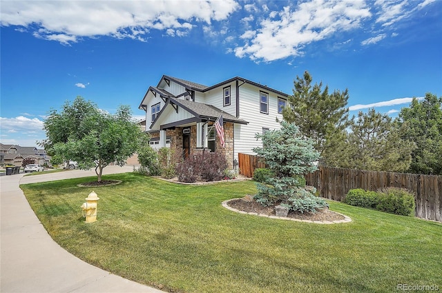 view of front of property featuring a yard, fence, a garage, and driveway