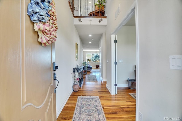 foyer entrance with recessed lighting, visible vents, light wood-style flooring, and baseboards