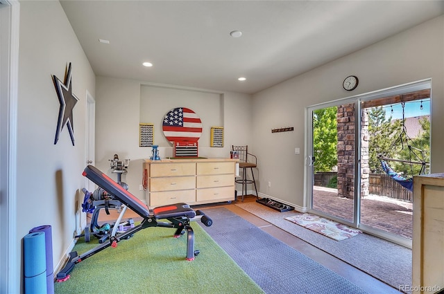 workout area featuring recessed lighting and baseboards