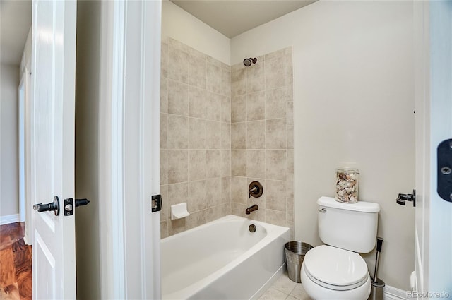 full bathroom with  shower combination, toilet, and baseboards