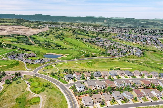 drone / aerial view featuring a residential view, a mountain view, and view of golf course