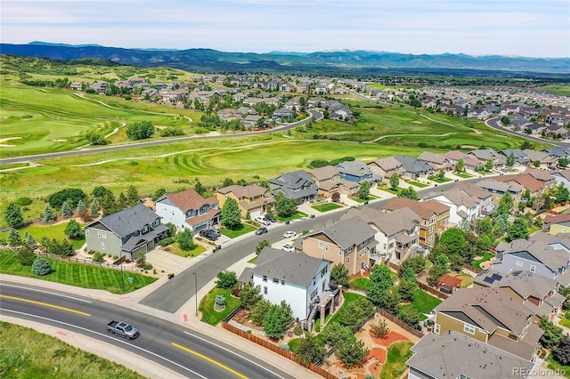 aerial view with a residential view, a mountain view, and golf course view