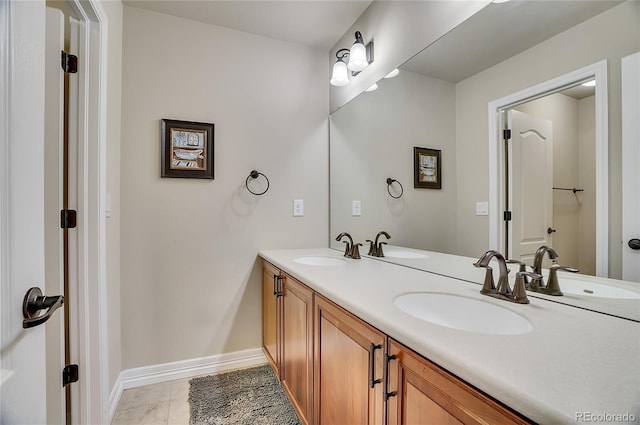 full bath featuring baseboards and a sink