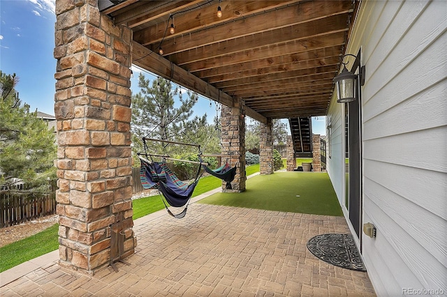 view of patio / terrace featuring fence