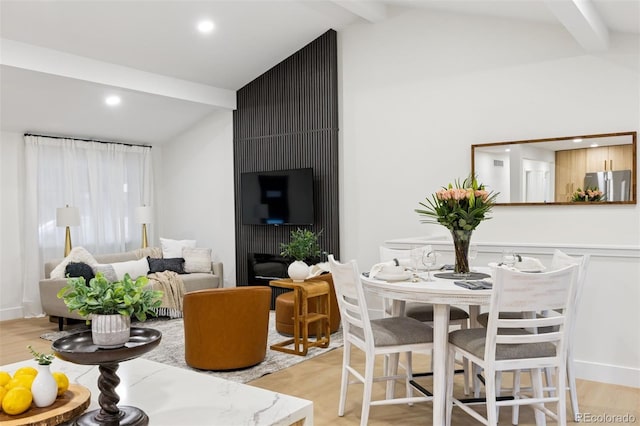 interior space featuring recessed lighting, vaulted ceiling with beams, and light wood finished floors