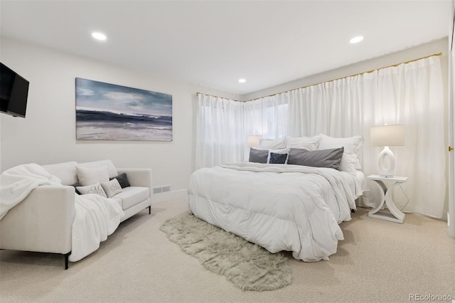 carpeted bedroom featuring recessed lighting, visible vents, and baseboards