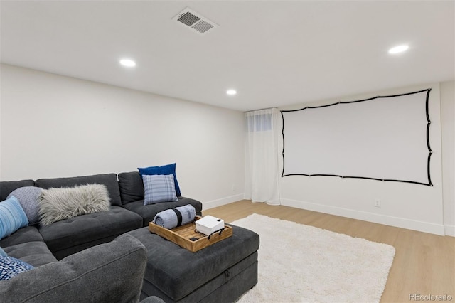 home theater room with baseboards, light wood-style flooring, visible vents, and recessed lighting