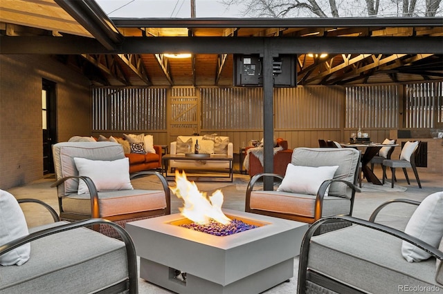 view of patio / terrace featuring outdoor dining space and an outdoor living space with a fire pit