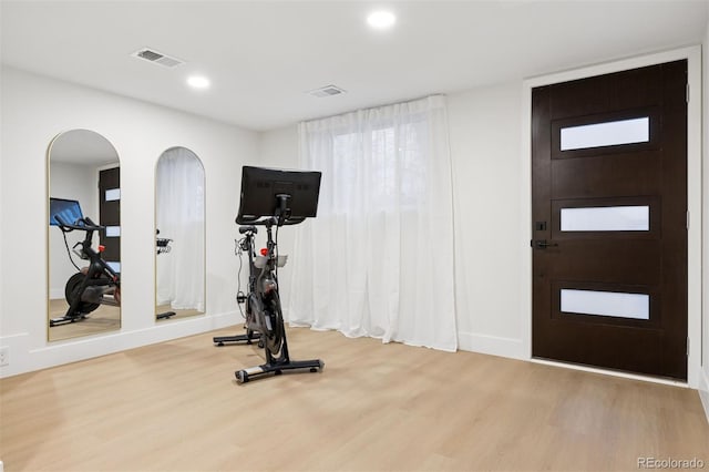 workout area with recessed lighting, visible vents, and wood finished floors