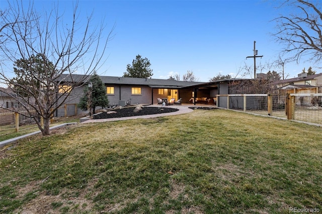 rear view of property featuring fence, a patio, and a yard