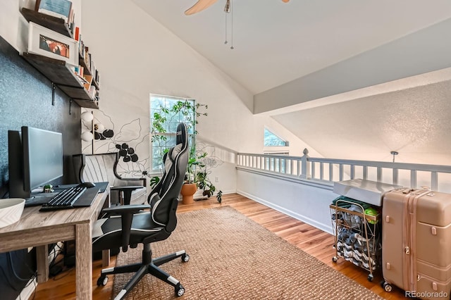 office area with ceiling fan, wood finished floors, and high vaulted ceiling