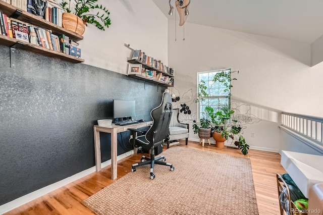 office space featuring baseboards and wood finished floors