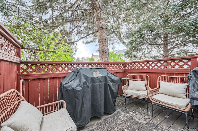 wooden deck featuring grilling area and fence
