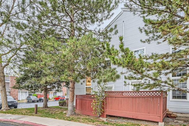 view of side of home featuring fence