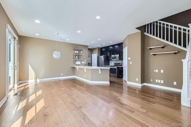 11323 Uptown Ave, Broomfield, CO 80021 - unfurnished living room featuring visible vents, light wood-style flooring, baseboards, and recessed lighting