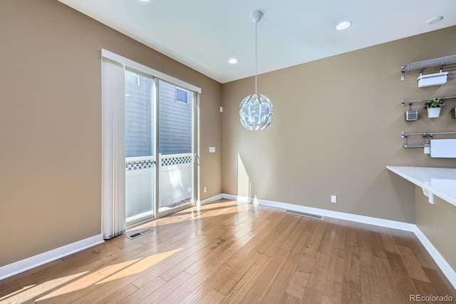 11323 Uptown Ave, Broomfield, CO 80021 - unfurnished dining area featuring wood-type flooring, visible vents, and baseboards